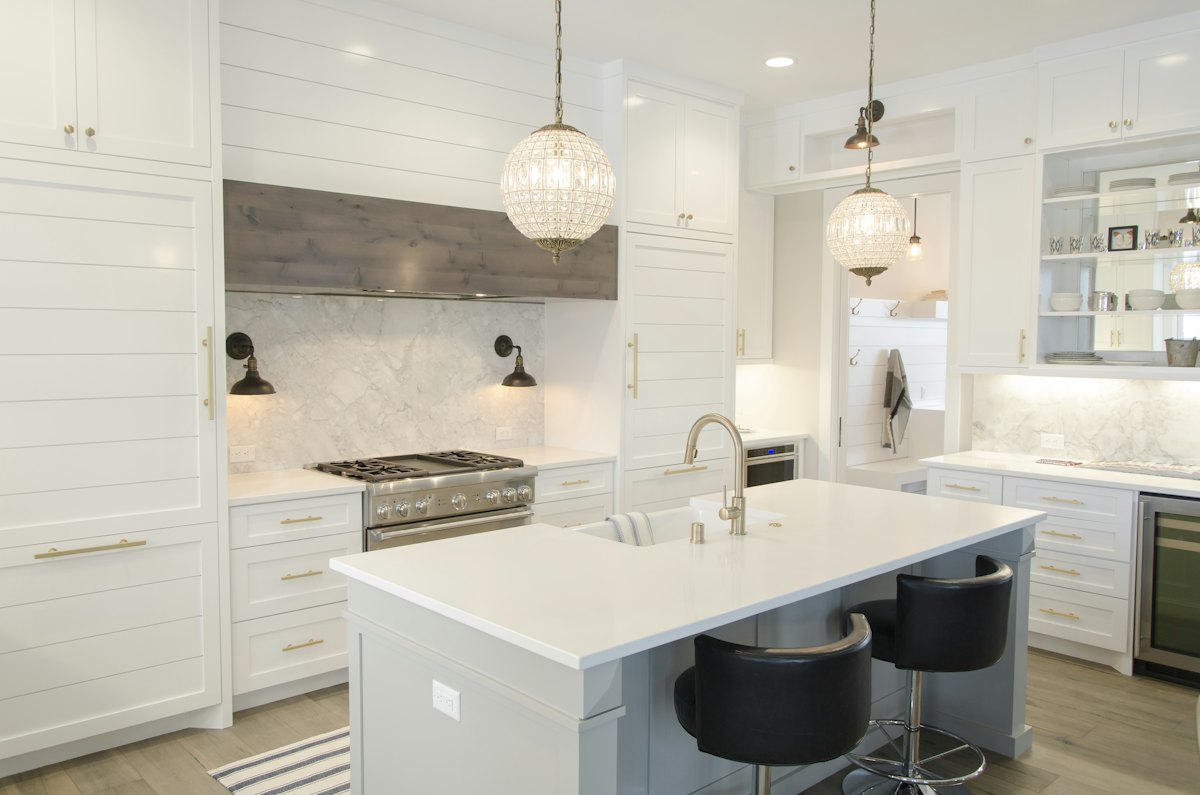 A bright, finished white kitchen with an island, ready to list